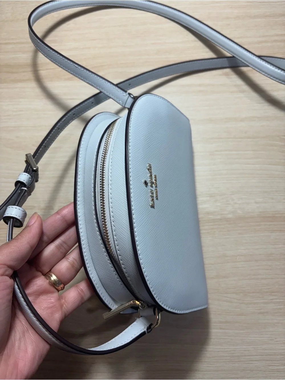 kate spade cream dome crossbody with gold logo